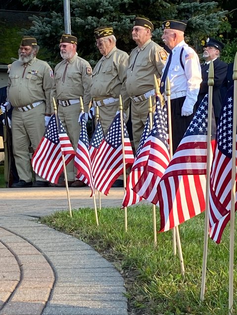 Thirteen flags, symbolizing the lives of American soldiers lost in Afghanistan, frame members of Tusten-Highland-Lumberland VFW Post 6427 at Heroes Park in Eldred.